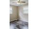 Bedroom with neutral walls, hardwood floors, two windows with blinds, and a ceiling fan at 18 Shannon Ct, Newton, NC 28658
