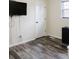 Bedroom features hardwood floors, a window, and a wall-mounted TV with power cords and a white door at 18 Shannon Ct, Newton, NC 28658