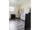 Bright bedroom features hardwood floors, a window, and a white baby crib with baby clothes on a rack at 18 Shannon Ct, Newton, NC 28658