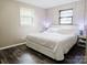 Bedroom showcasing a bed with white linens, two windows, hardwood floors, and two bedside tables at 18 Shannon Ct, Newton, NC 28658