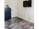 Bedroom features hardwood floors, a wall-mounted TV with cords, and a dark-stained wooden dresser at 18 Shannon Ct, Newton, NC 28658