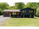 Charming exterior of a black home with wooden shutters and a well-manicured lawn at 18 Shannon Ct, Newton, NC 28658