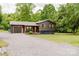 Charming home with gravel driveway, landscaped yard, and a garage with stylish wooden doors at 18 Shannon Ct, Newton, NC 28658