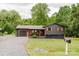 Home exterior featuring a gravel driveway, wooden shutters, and a well-manicured lawn at 18 Shannon Ct, Newton, NC 28658