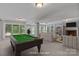Staged basement with pool table, ample seating, and fireplace at 1806 Asbury Hall Ct, Charlotte, NC 28209