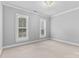 Bright bedroom with neutral walls, two windows, and plush carpet at 1806 Asbury Hall Ct, Charlotte, NC 28209