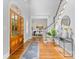 Welcoming foyer featuring hardwood floors, staircase, and a dining room view at 1806 Asbury Hall Ct, Charlotte, NC 28209