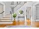 Welcoming foyer with hardwood floors, a staircase, and natural light streaming through the front door at 1806 Asbury Hall Ct, Charlotte, NC 28209