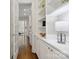 Hallway with hardwood floors, white cabinets, and designer lighting at 1806 Asbury Hall Ct, Charlotte, NC 28209