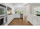 Bright kitchen featuring stainless appliances, subway tile backsplash, and access to dining area at 1806 Asbury Hall Ct, Charlotte, NC 28209