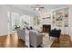 Bright living room features fireplace, built-in shelving, and hardwood floors at 1806 Asbury Hall Ct, Charlotte, NC 28209