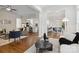 Open-concept living room featuring hardwood floors and seamless flow to the kitchen and breakfast nook at 1806 Asbury Hall Ct, Charlotte, NC 28209