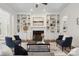 Elegant living room with built-in bookshelves flanking a fireplace and stylish seating arrangement at 1806 Asbury Hall Ct, Charlotte, NC 28209