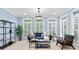 Sitting room with plantation shutters, a blue couch and bright, natural light at 1806 Asbury Hall Ct, Charlotte, NC 28209