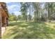 Spacious, fenced backyard featuring mature trees and a lush lawn at 205 Timberfield Trl, China Grove, NC 28023