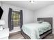Cozy bedroom with natural light, neutral tones, and a wooden frame bed at 205 Timberfield Trl, China Grove, NC 28023