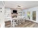 Bright dining room featuring a dining table, built-in shelves, and a charming fireplace at 205 Timberfield Trl, China Grove, NC 28023