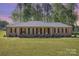 Charming single-story brick home featuring arched entryway, manicured lawn and mature trees at 205 Timberfield Trl, China Grove, NC 28023