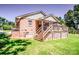 Home exterior featuring a wooden deck, brick siding, and green lawn, perfect for outdoor enjoyment and relaxation at 209 Woodstream Cir, Mooresville, NC 28117