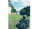 Lake Wylie home backyard features a fire pit, spacious lawn, and scenic lake view, ideal for outdoor entertaining at 209 Woodstream Cir, Mooresville, NC 28117