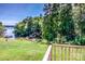 View of a lush green lawn and the lake from a wooden deck overlooking the water at 209 Woodstream Cir, Mooresville, NC 28117