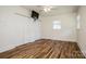 Bedroom featuring hardwood floors, fresh paint, a ceiling fan, and large closet space at 209 Woodstream Cir, Mooresville, NC 28117
