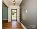 Inviting foyer with hardwood floors and a view of the front yard through the open doorway at 209 Woodstream Cir, Mooresville, NC 28117