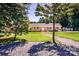 Traditional brick home with shutters, landscaping, and a stone path leading to the front door, framed by mature trees at 209 Woodstream Cir, Mooresville, NC 28117