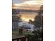 Picturesque lake view with a stunning sunset, private docks, and calm waters reflecting the colorful sky at 209 Woodstream Cir, Mooresville, NC 28117