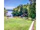 Scenic lake view from the backyard featuring lush greenery, calm waters, and private boat docks at 209 Woodstream Cir, Mooresville, NC 28117
