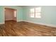 Bright living room with light-green walls, hardwood flooring, and large windows providing ample natural light at 209 Woodstream Cir, Mooresville, NC 28117