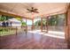 Inviting screened-in porch with wood flooring and ceiling fan overlooking backyard views and lush greenery at 209 Woodstream Cir, Mooresville, NC 28117