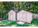Two storage sheds with double doors for backyard storage, surrounded by mature trees and a green lawn at 209 Woodstream Cir, Mooresville, NC 28117