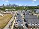 An aerial view of townhouses with a city skyline in the background on a bright sunny day at 2111 Isom St, Charlotte, NC 28208
