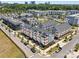 An aerial view of a neighborhood with modern townhouses, tree-lined streets, and beautiful landscaping at 2111 Isom St, Charlotte, NC 28208