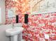 Stylish powder room with bright flamingo patterned wallpaper and modern sink at 2111 Isom St, Charlotte, NC 28208