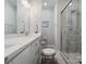 Bright bathroom features a glass shower, vanity with marble countertops and framed mirror at 2111 Isom St, Charlotte, NC 28208