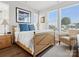 Bright bedroom features hardwood floors and large windows that provide lots of natural light at 2111 Isom St, Charlotte, NC 28208