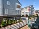 Modern townhomes with gray siding, wooden accents, and balconies overlooking a landscaped courtyard at 2111 Isom St, Charlotte, NC 28208