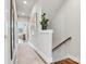 Hallway with a staircase and a plant by the banister leading to a naturally lit living room at 2111 Isom St, Charlotte, NC 28208