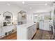 Bright kitchen with island, stainless steel appliances, and white cabinetry at 2111 Isom St, Charlotte, NC 28208