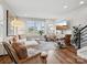 Spacious living room with hardwood floors, stylish decor, a large window, and a staircase at 2111 Isom St, Charlotte, NC 28208