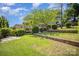 View of backyard and trees in landscaped yard with terraced planter beds at 2125 Chatham Ave, Charlotte, NC 28205
