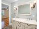 A bathroom with a double vanity, a large mirror, and decorative light fixtures for a luxurious feel at 2125 Chatham Ave, Charlotte, NC 28205