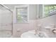 Traditional bathroom showcasing a window for natural light and classic white tile throughout at 2125 Chatham Ave, Charlotte, NC 28205
