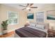Comfortable bedroom with natural light, neutral colors, and a ceiling fan for added comfort at 2125 Chatham Ave, Charlotte, NC 28205