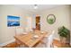 Bright dining room featuring hardwood floors, a modern table setting, and views of the garden at 2125 Chatham Ave, Charlotte, NC 28205