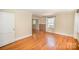 Spacious room with hardwood floors, ample natural light, and neutral walls, ideal for flexible living at 2125 Chatham Ave, Charlotte, NC 28205