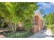 Exterior view of brick home surrounded by mature landscaping at 2125 Chatham Ave, Charlotte, NC 28205