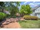 Charming brick home with lush landscaping, a brick walkway, and mature trees in a desirable neighborhood at 2125 Chatham Ave, Charlotte, NC 28205